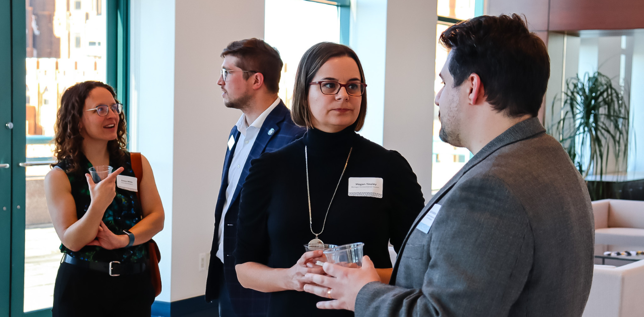 Members of the Environmental Council, center, talk to supporters during a 2024 Detroit policy soiree.
