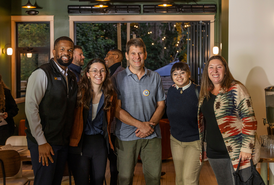 Grand Rapids Mayor David LaGrand, center, poses with attendees of a Climate Cabinet Action happy hour. (Photo courtesy of Carbon Stories.)