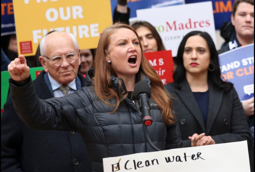 A protester yells while holding a pro-environment sign at a rally. (Photo courtesy of NRDC)